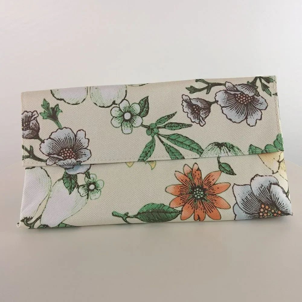 Clinique cream floral print fold over makeup / jewelry bag.